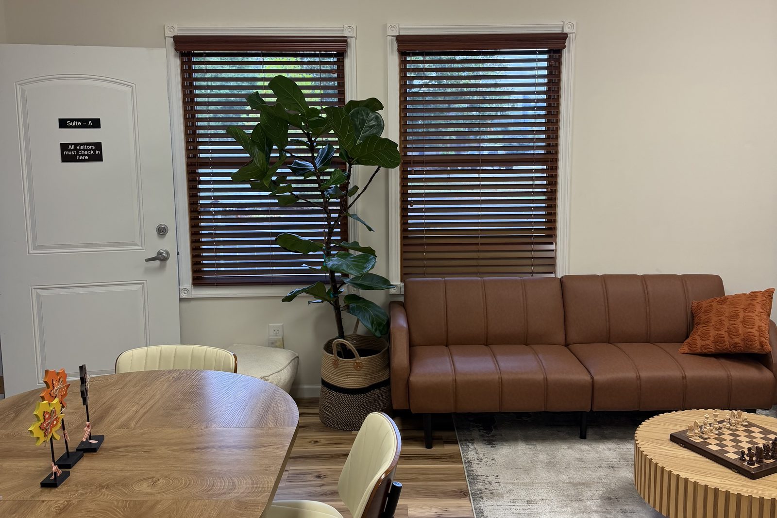 Client lounge with a wooden table, a sofa, and a chess set