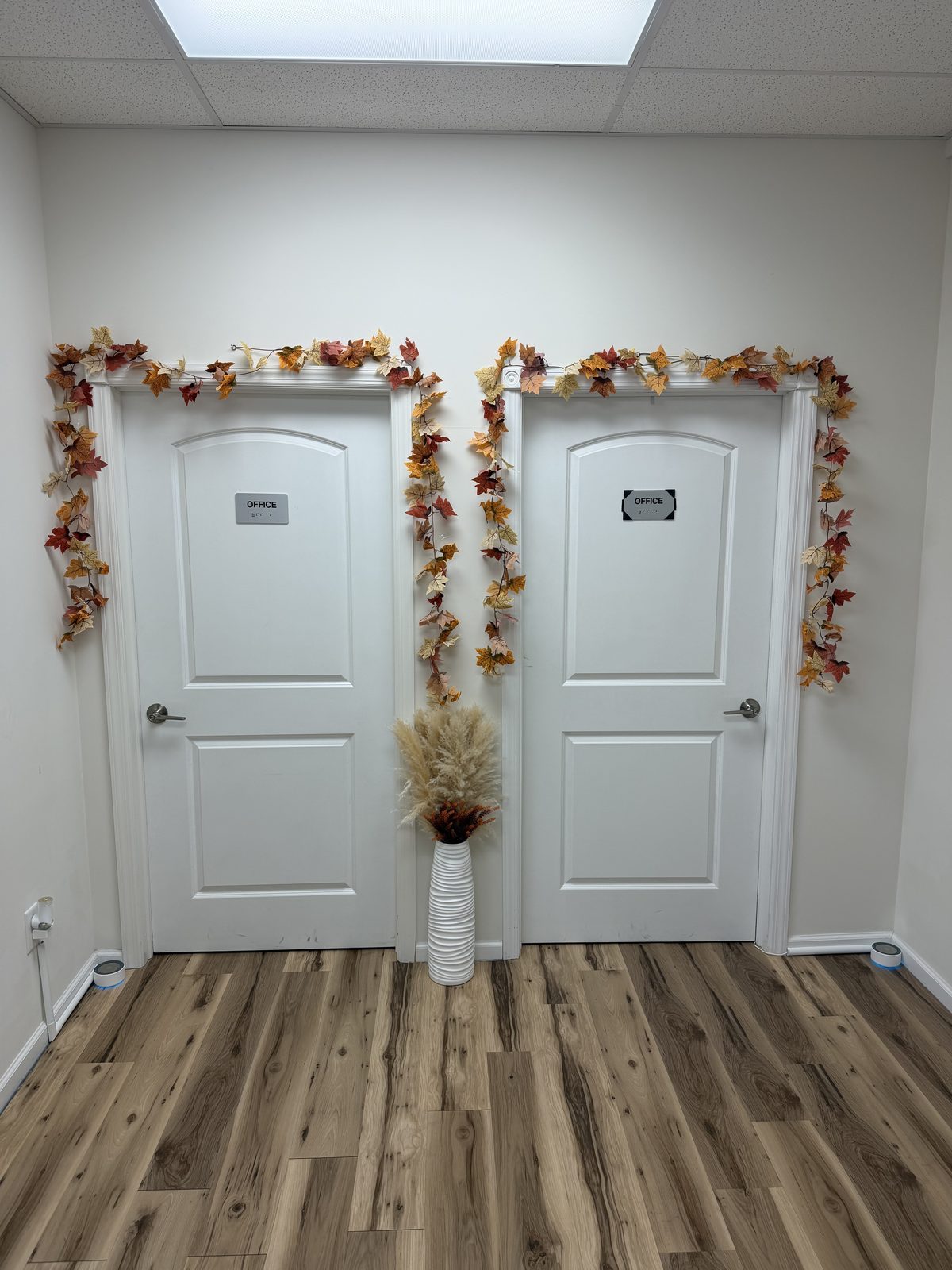 Two office doors at the end of a hallway