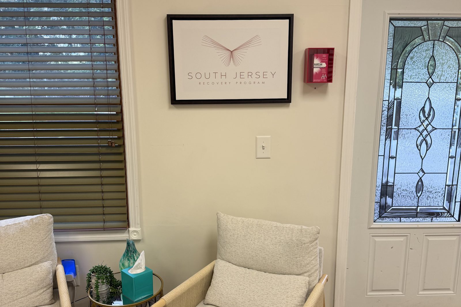 Waiting area with armchairs beneath the South Jersey Recovery Program sign